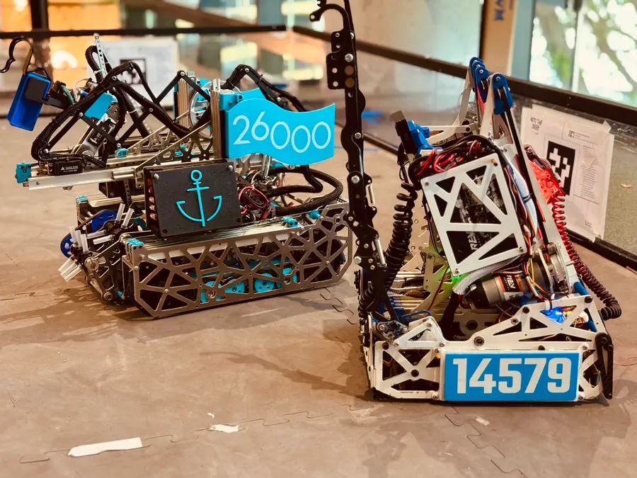 Two Theseus robots with the 26000 flag